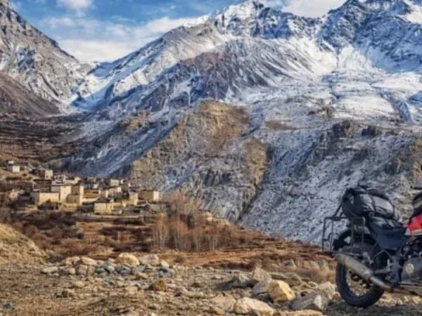 Motorbike rider on a mountain road in Lower Mustang Nepal with Kali Gandaki gorge in the background