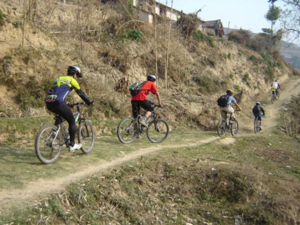Mountain biker on a gravel track in the Kali Gandaki valley, Mustang, Nepal