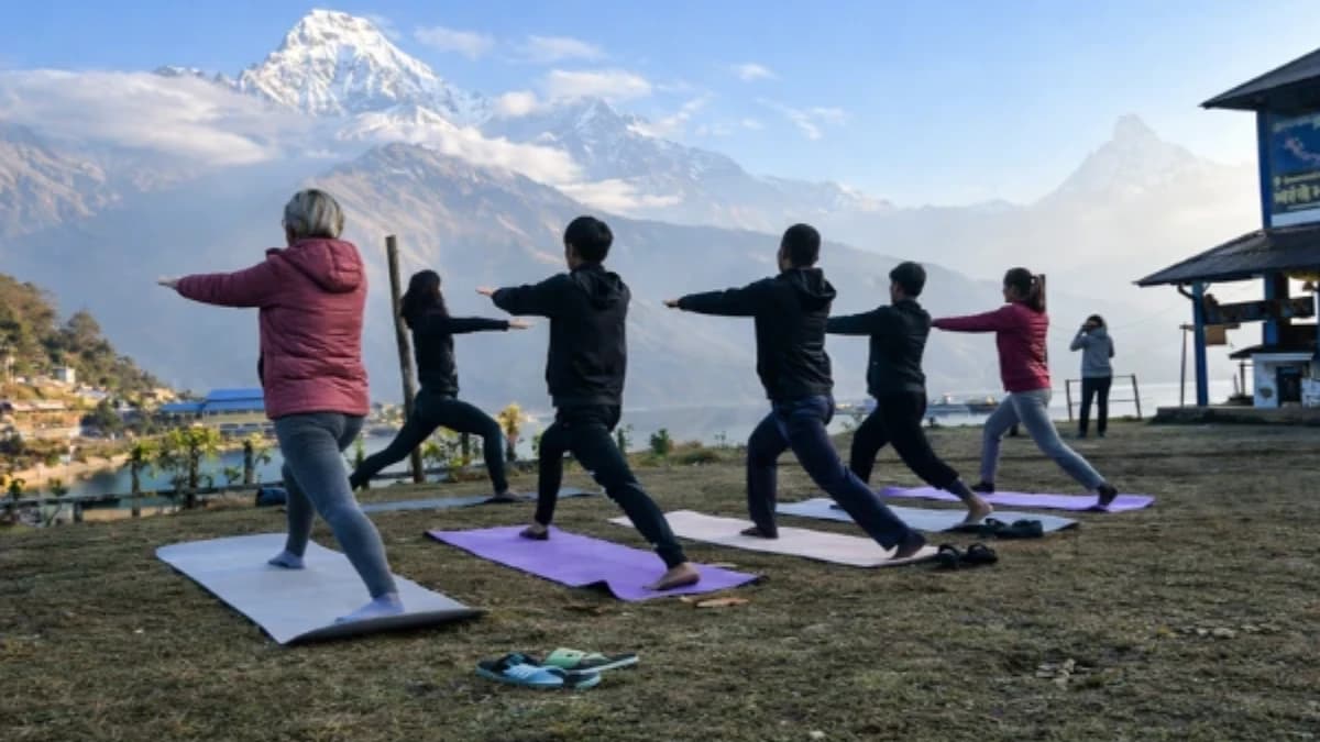 People doing outdoor yoga with mountain view.