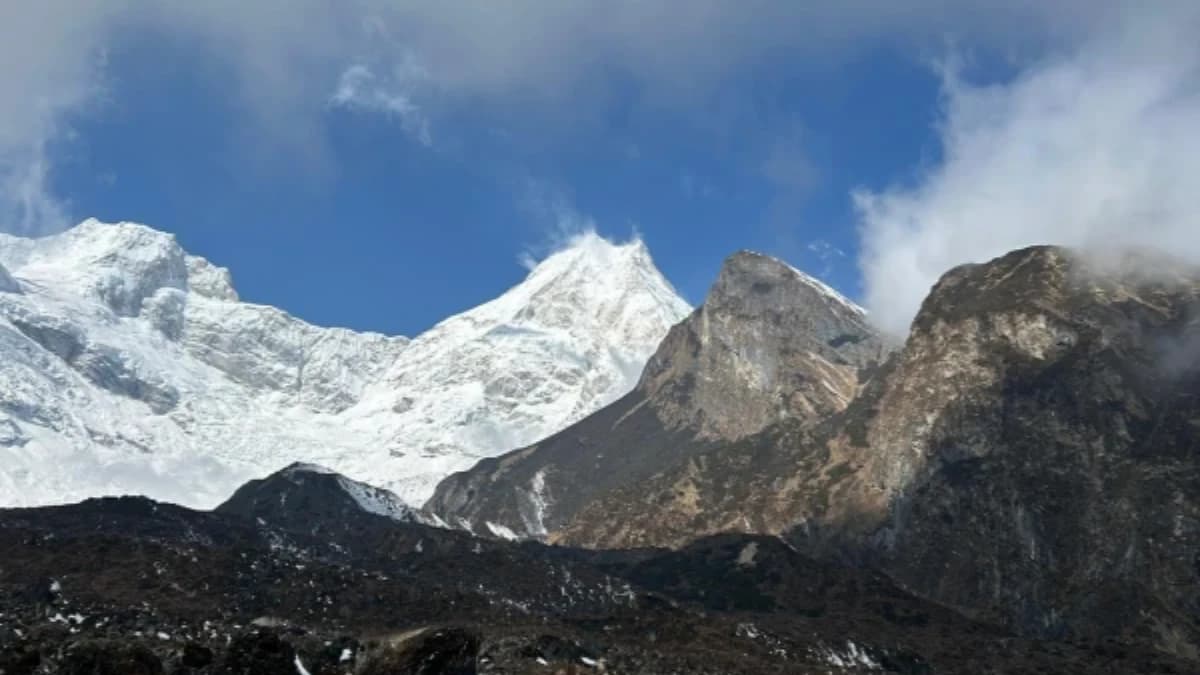 Ancient Buddhist chortens and mani walls in Tsum Valley, Nepal with Himalayan mountain views.