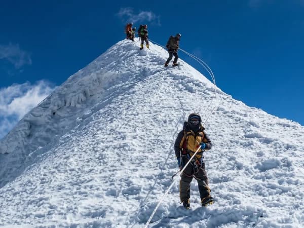 Climbers on a snow ridge in the Everest region of Nepal.