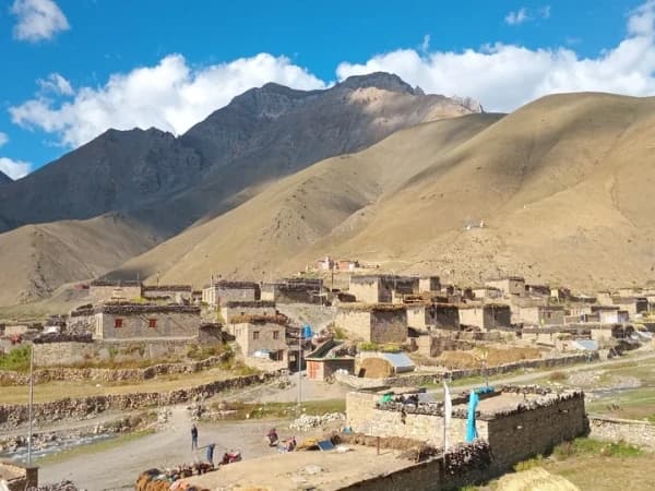 Ancient Buddhist stupas in Lower Dolpo, Nepal with desert mountains in the background.