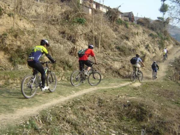 Mountain bikers on a dirt ridge track above the Kathmandu valley on the Nagarkot day ride, Nepal