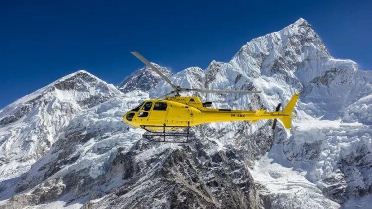 Mountain rescue and transport helicopter at a remote Himalayan landing site.