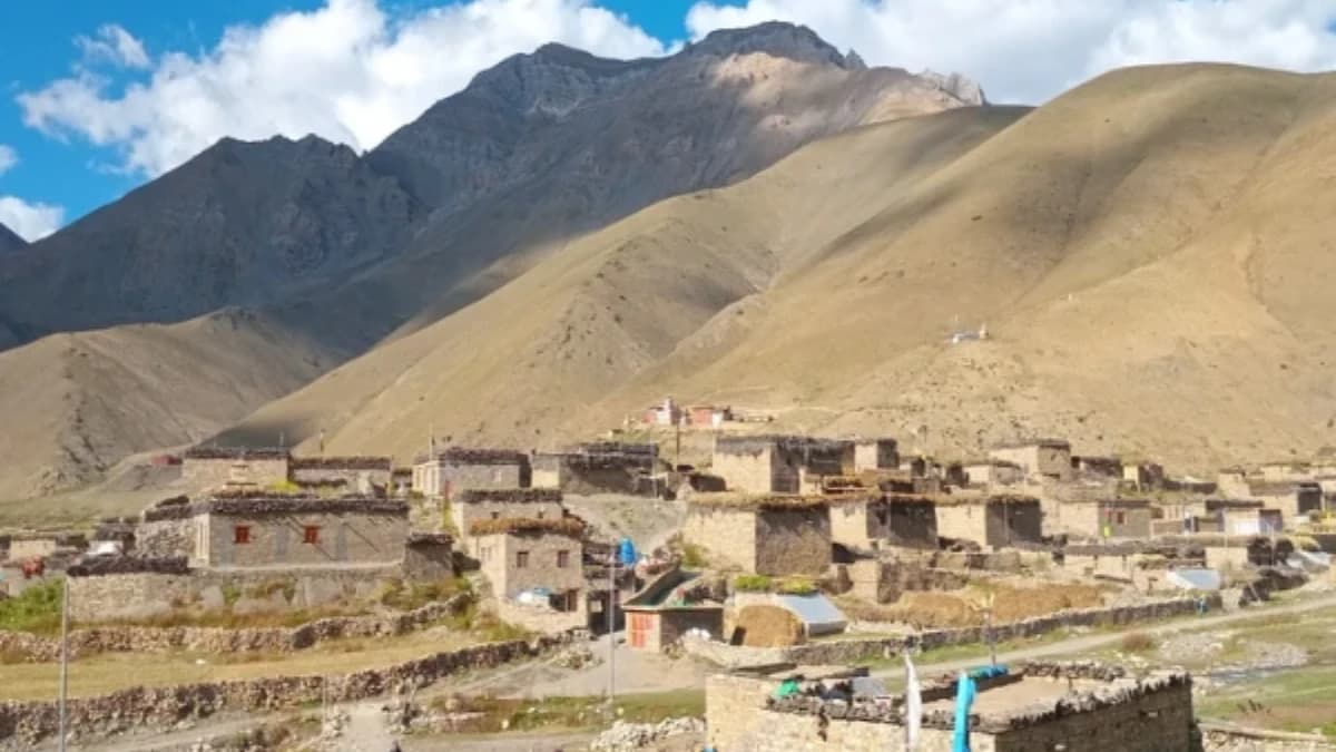 Ancient Buddhist stupas in Lower Dolpo, Nepal with desert mountains in the background.