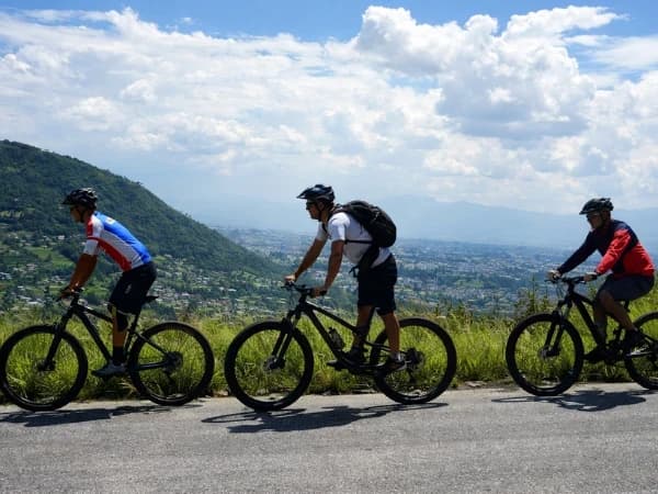 Group Mountain biking on a scenic hill route near Kathmandu Valley, Nepal
