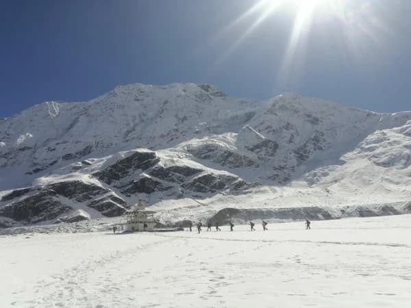 Ancient Buddhist chortens and mani walls in Tsum Valley, Nepal with Himalayan mountain views.
